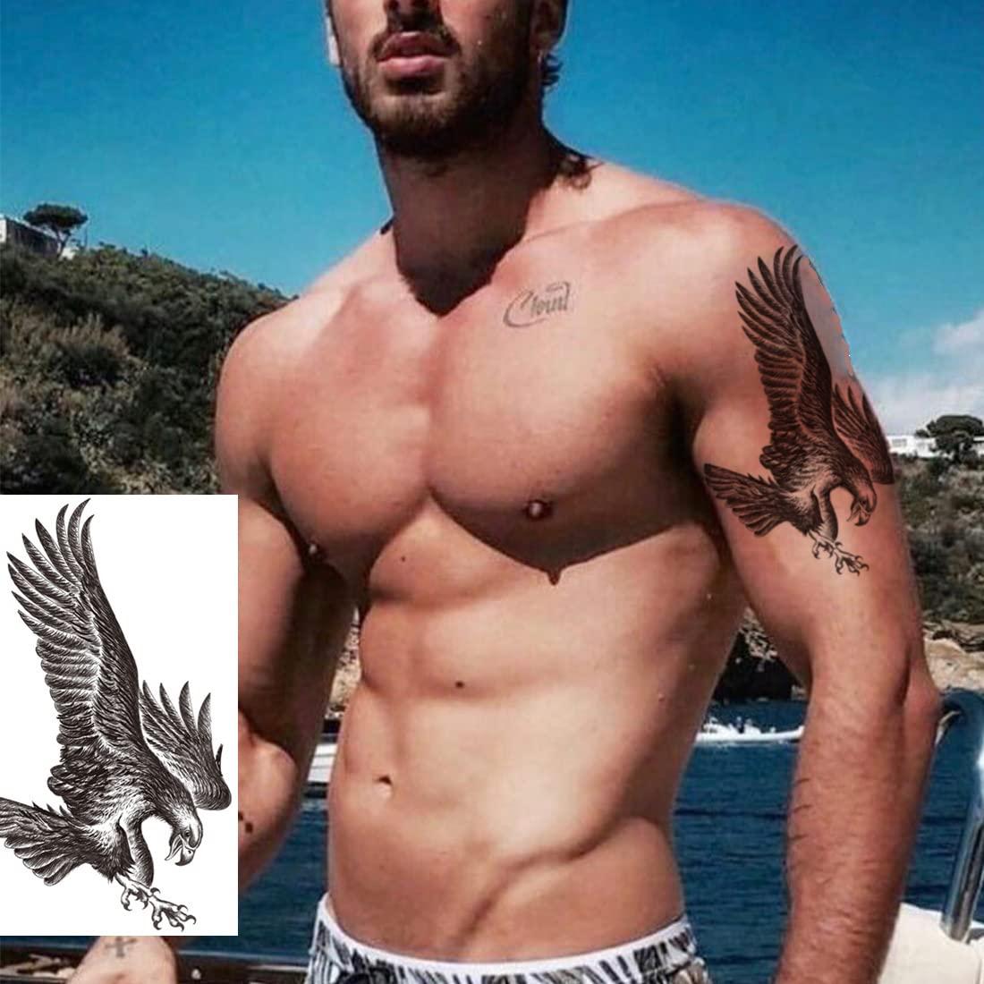 Premium Photo | A fierce and majestic eagle in flight tattoo on man AI  generated