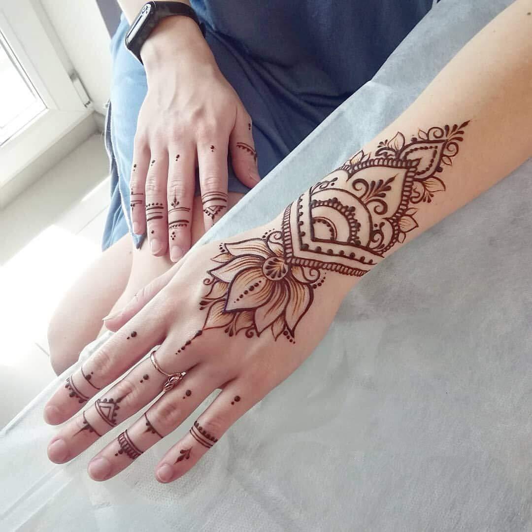 Female hands with henna tattoo on white background Stock Photo - Alamy