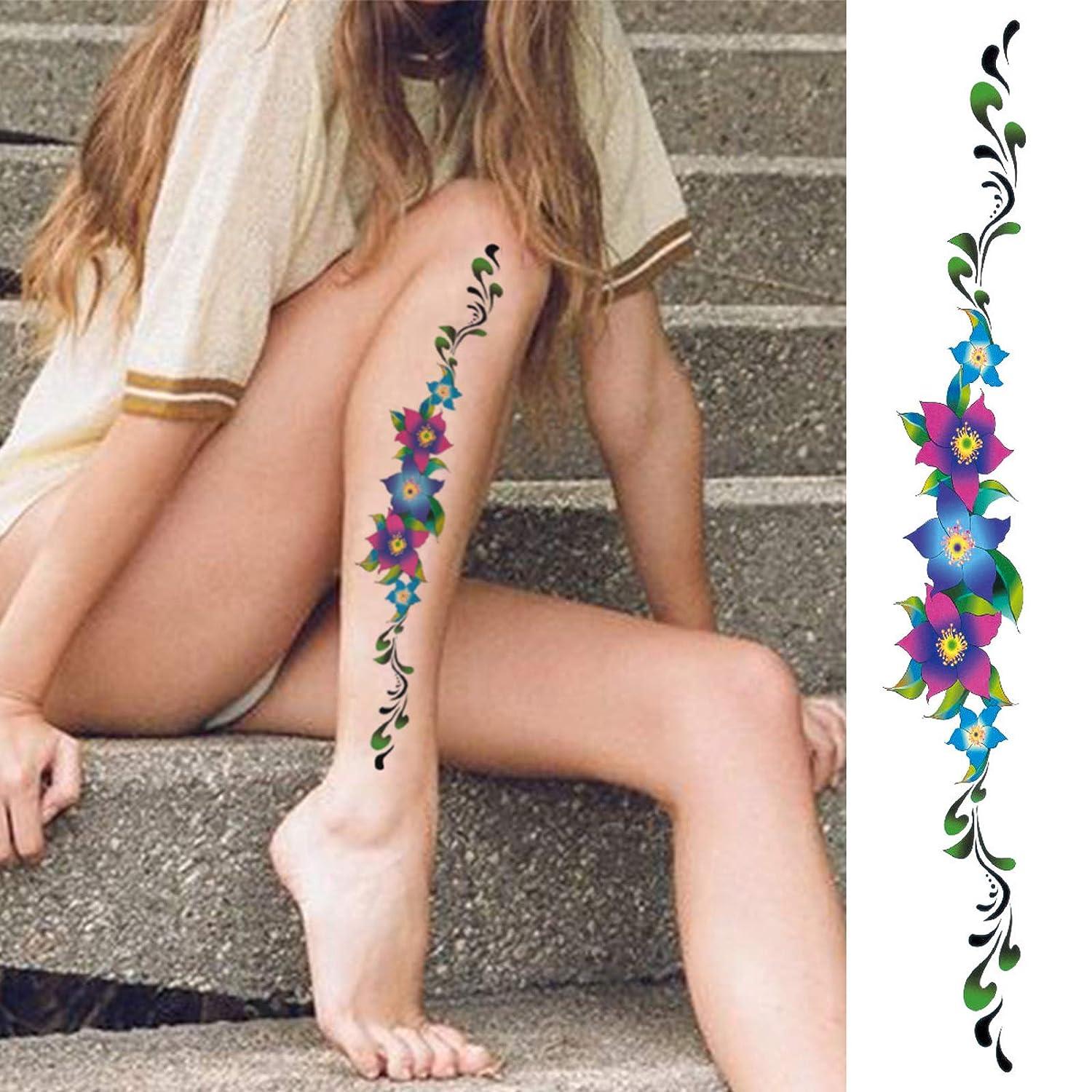 Fine line flower tattoo on the ankle.